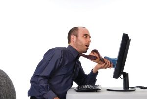 business man getting grabbed by a hand on computer
